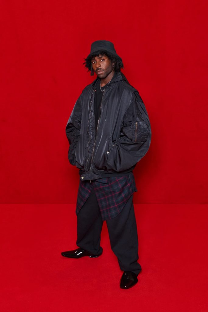 Image of R&B Artist Blood Orange from Balenciaga's runway show with the Simpsons. Promoting digital and virtual fashion.